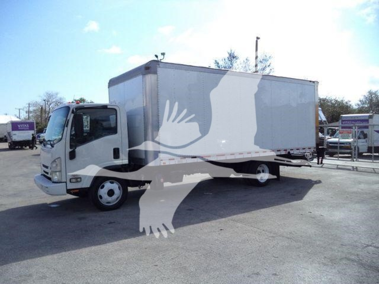 Isuzu NPRX box truck in side view showing stock number 210707FM and used vehicle status.