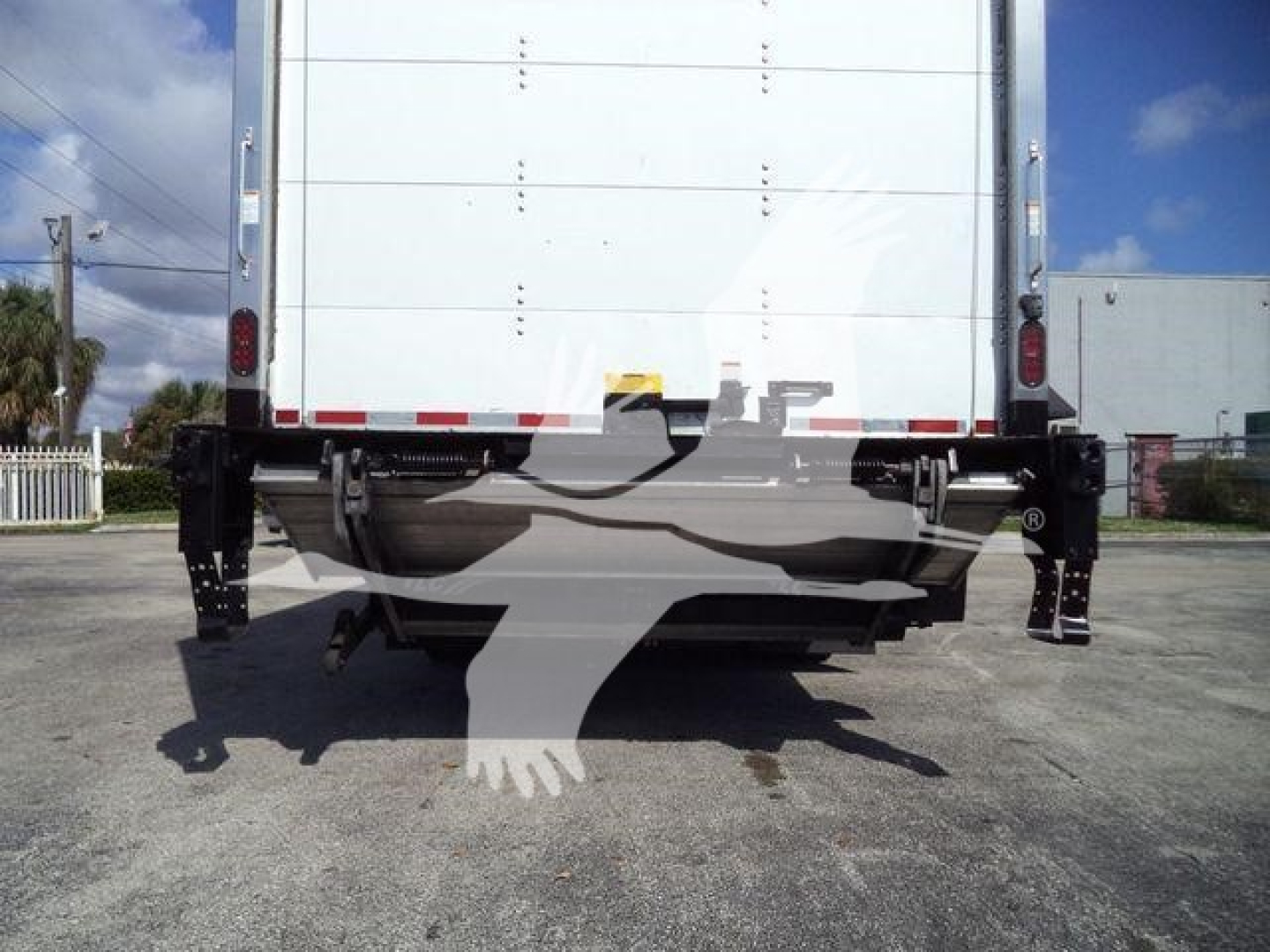 Isuzu NRR truck rear view showing cargo box with rear bumper, frame, and landing gear; no legible text visible on the image itself.