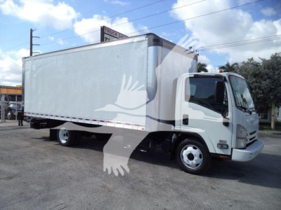 Isuzu box truck with a large white cargo box mounted on a cab chassis; text on sign in background blurred; no legible model details visible on the truck.