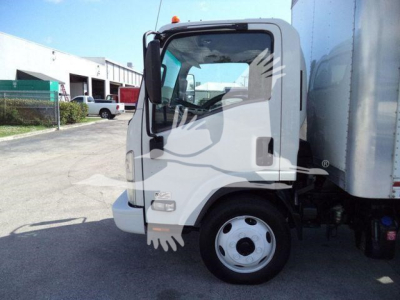 Isuzu NPR truck cab side view showing front wheel and box truck body.