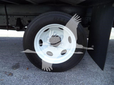 Isuzu NPRR rear wheel and tire visible under truck.