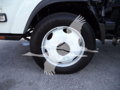 Isuzu NRR truck wheel and white steel rim with tire visible