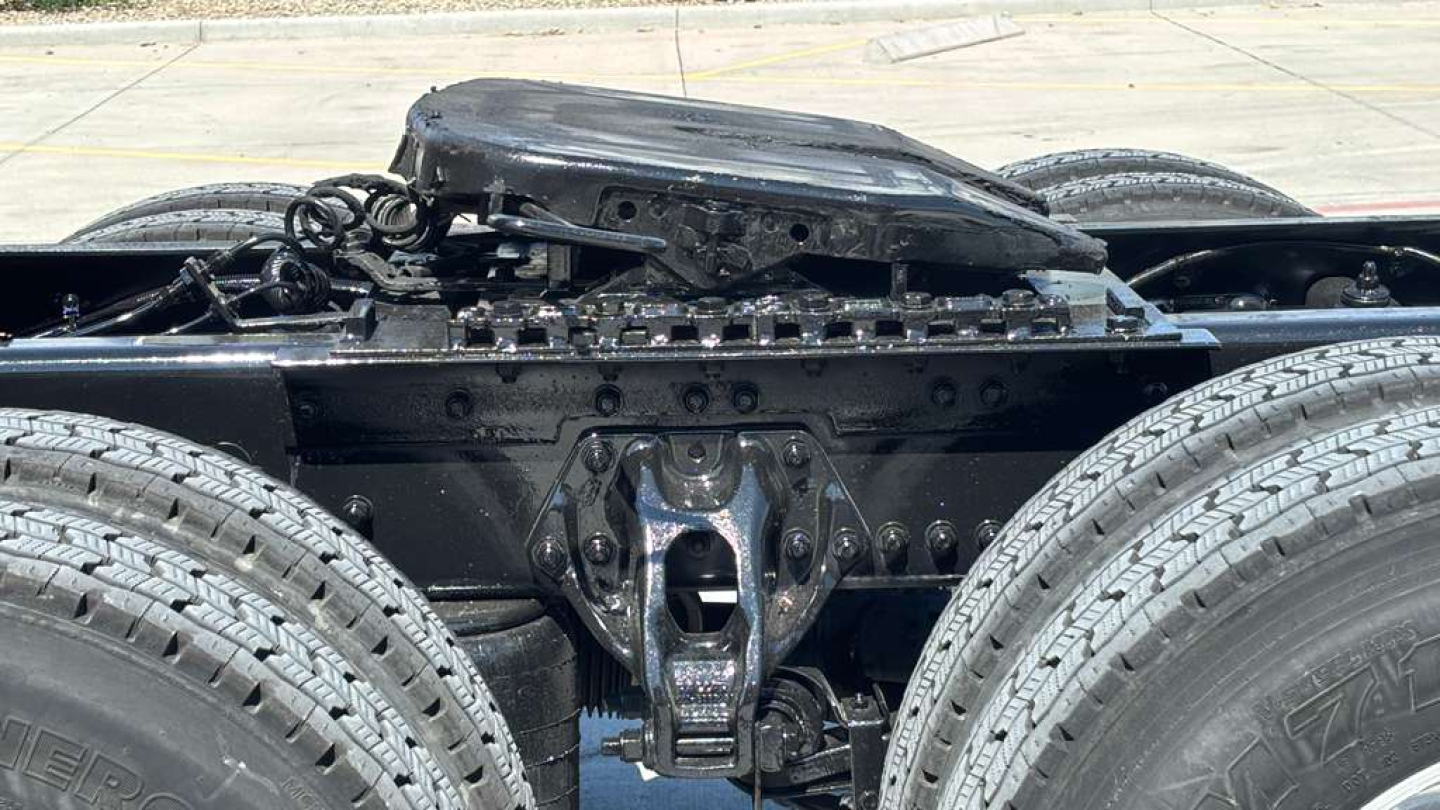 Kenworth T680 truck chassis rear view showing fuel tank, frame, and suspension components with wheels visible.
