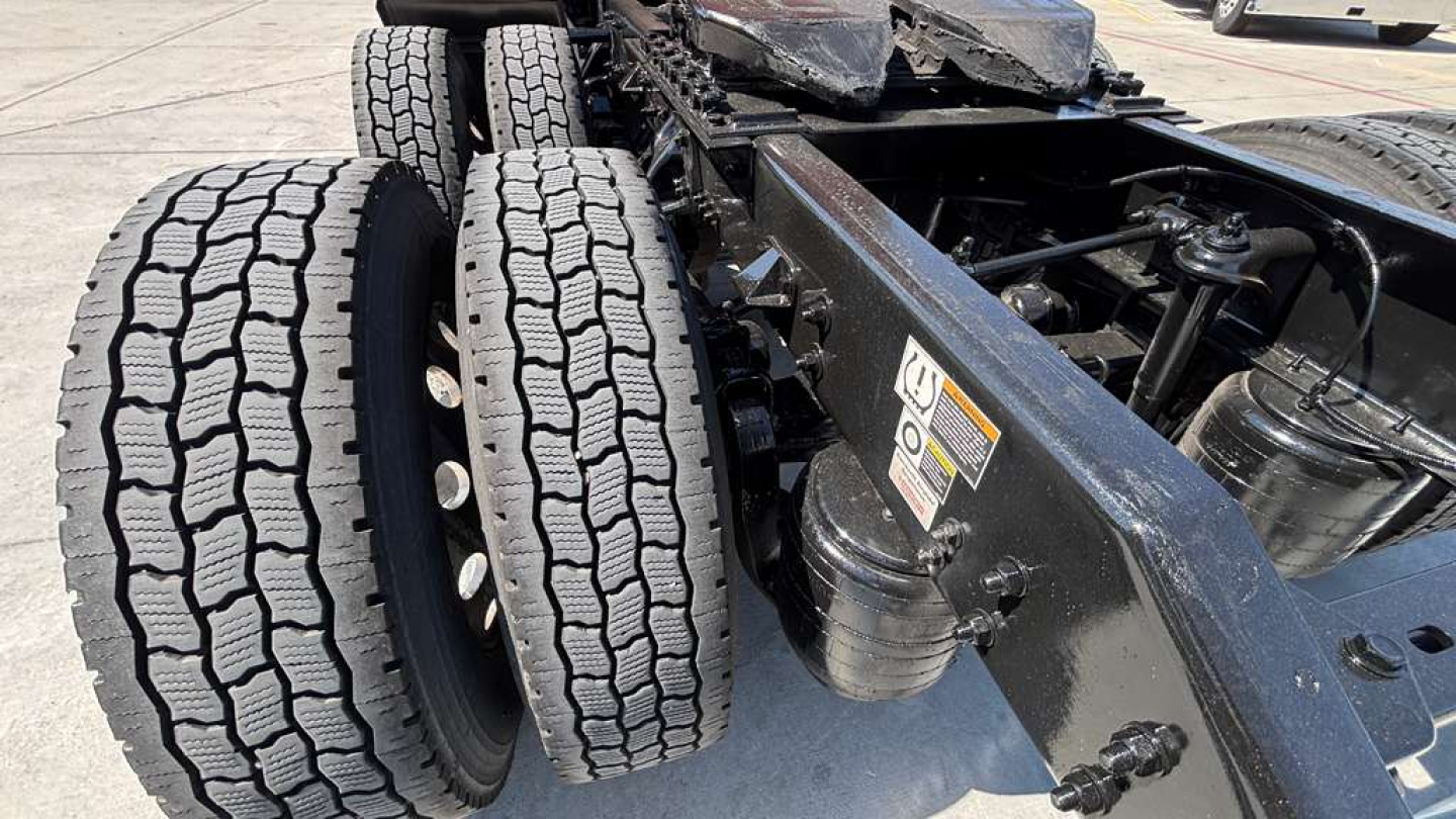 Kenworth T680 truck chassis rear with dual rear axles and large treaded tires; VIN and stock number not visible on this view.