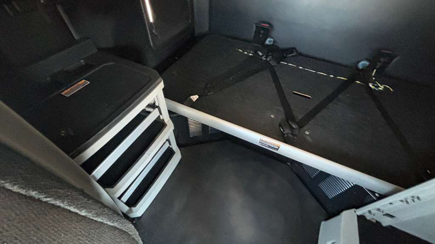 Kenworth T680 cabin interior showing sleeper area with seat belts and storage drawers in view