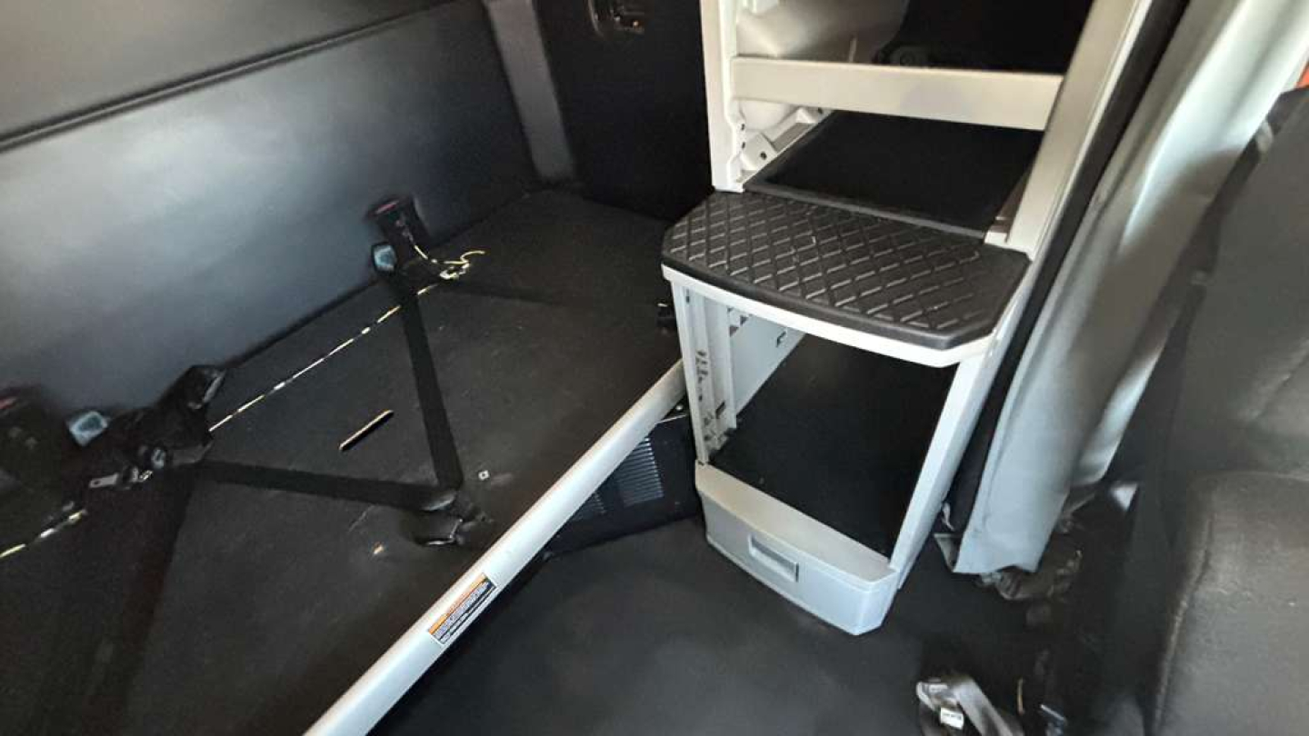 Kenworth T680 sleeper cab interior showing storage steps and platform.
