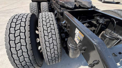 Kenworth T680 truck chassis rear with dual rear axles and large treaded tires; VIN and stock number not visible on this view.