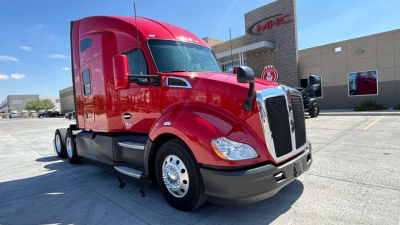 Kenworth T680 sleeper cab truck in red color, front-left view, with chrome grille and large mirrors.