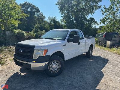 White 2014 Ford F-150 extended cab pickup truck parked on dirt lot, showing side and front view.