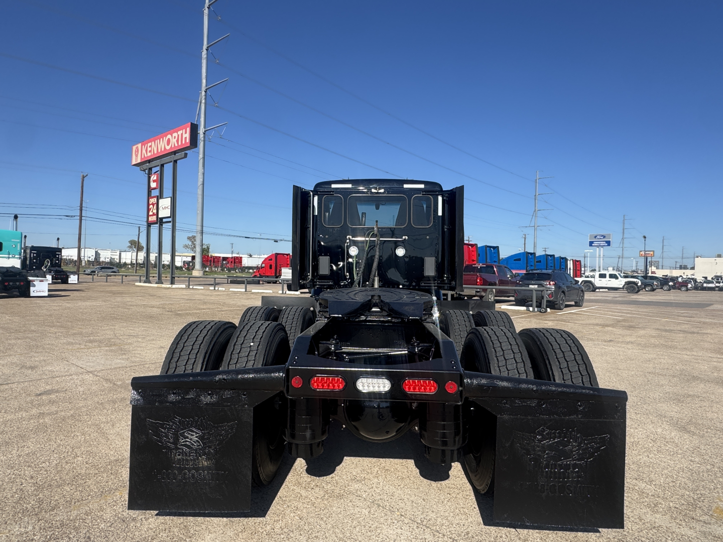 Peterbilt 579 tractor rear view showing dual rear axles and mudflaps.