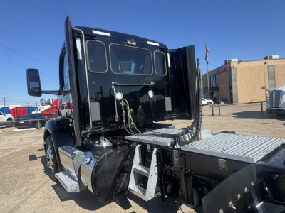 Peterbilt 579 convention daycab rear/side view showing steps and fuel tank with chrome accents and access steps.