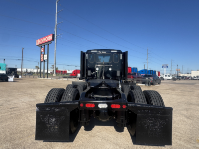 Peterbilt 579 tractor rear view showing dual rear axles and mudflaps.
