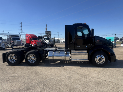 Peterbilt 579 truck side view showing chrome fuel tanks and wheels