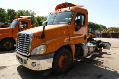 Orange 2017 Freightliner Cascadia 125 conventional daycab truck, front-left view, VIN 1FUJGEDV1HLHZ1373 visible with stock number 1112244.