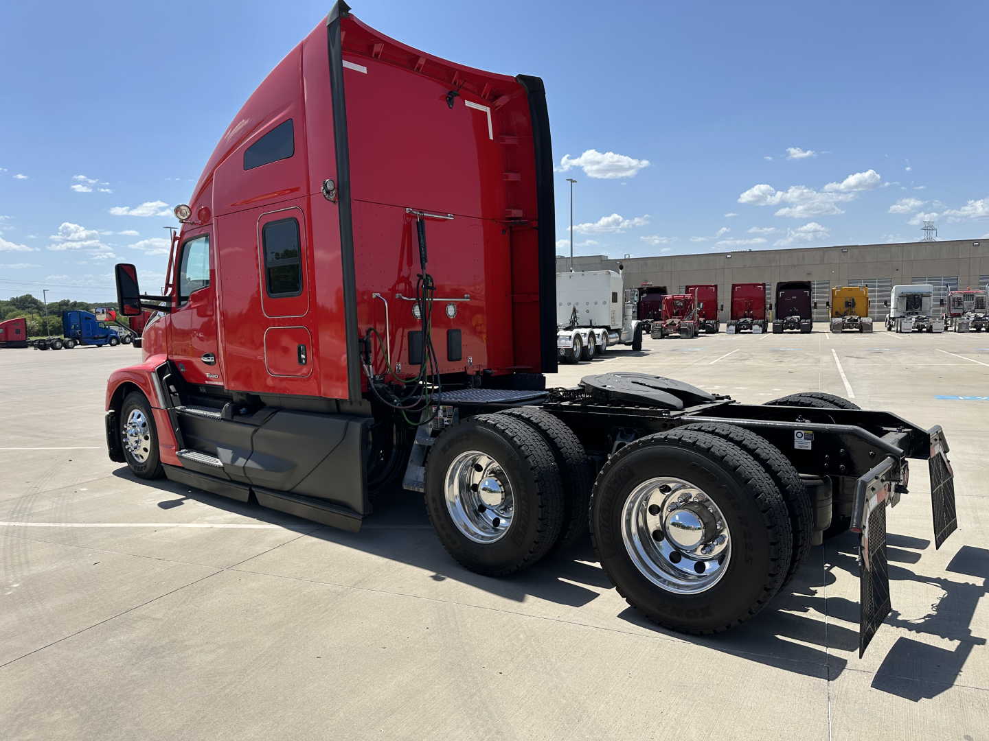 Kenworth T680 6x4 tractor tractor cab red right-side view showing sleeper cab and rear chassis with dual rear wheels.