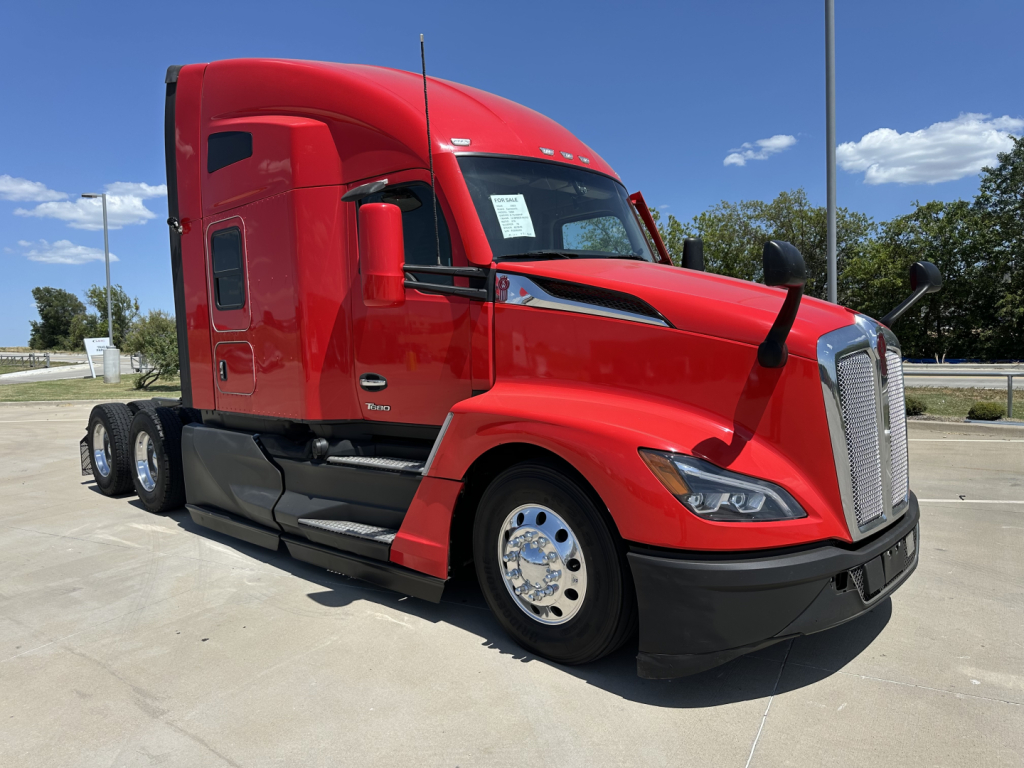 Kenworth T680 tractor-trailer in red, side view, cab and front grille with dual rear axles visible.