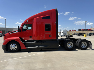 Red 2023 Kenworth T680 conventional sleeper tractor in side view showing cab, fuel tanks, and dual rear axles.