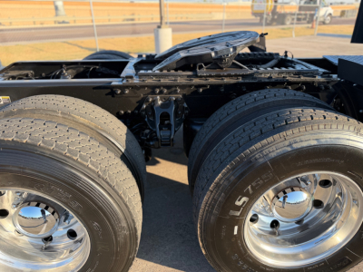 Kenworth W900L truck rear dual rear axles showing tandem drive tires and chrome rims.