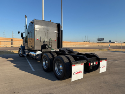 Kenworth W900L semi-truck rear and cab, chrome exhaust stacks, dual rear axles, mudflaps with MHC logo.