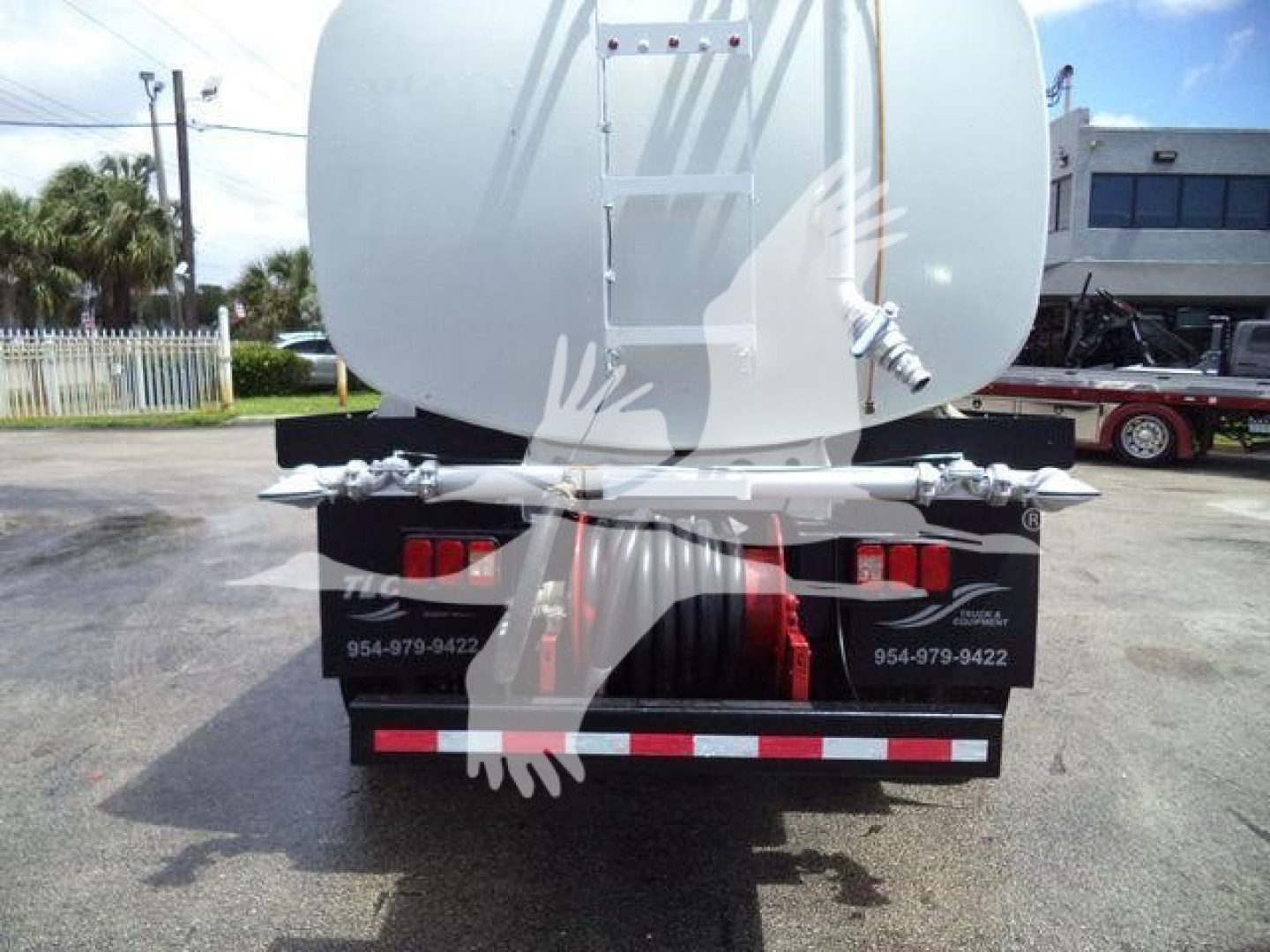 Rear view of 2015 Ford F650 SD truck showing tanker and rear bumper with stock contact numbers.