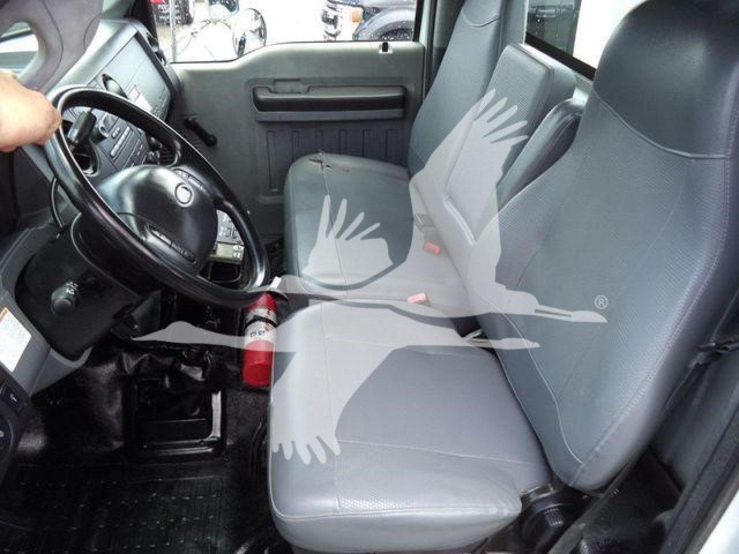Truck interior showing front seats and steering wheel with gray fabric seats and black dashboard.
