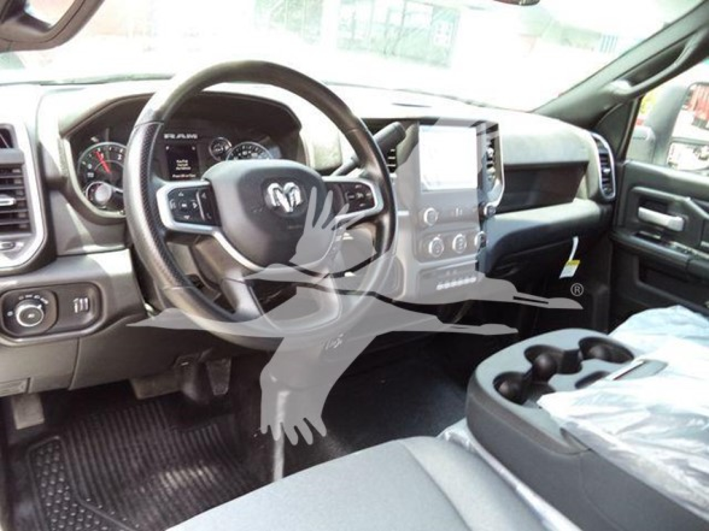 Ram 5500 interior: steering wheel with Ram logo, dashboard gauges, center infotainment screen, gear shifter, cup holders visible.