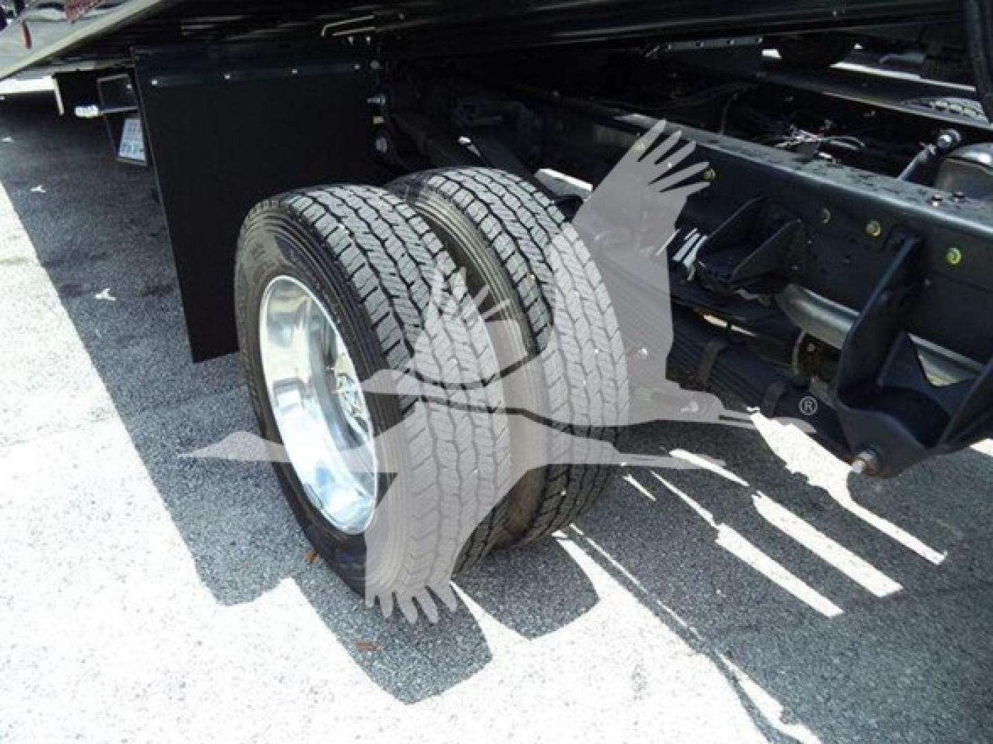 Ram 5500 rollback truck rear dual tire assembly and chassis view showing tires and frame rails.