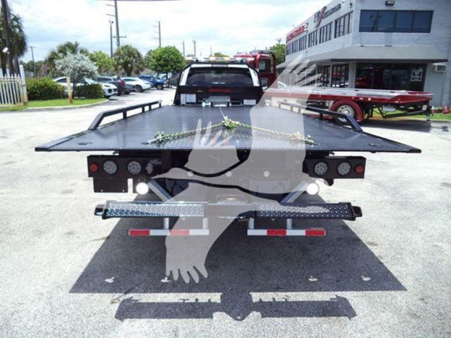 Ram 5500 rollback tow truck bed with flat deck and rear lights, seen from rear view.