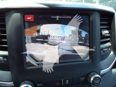 Ram 5500 dash showing infotainment screen with rear camera view and warning 'Check Entire Surroundings'