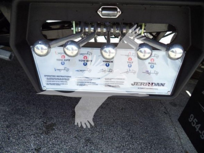 Ram 5500 rollback tow plate with joystick and control diagram showing labels; Jerr-Dan branding; components and chrome pins visible under rear bumper.