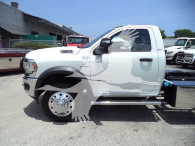 Ram 5500 SLT pickup truck side profile showing single cab, white color, with front fender badge and large wheel, rollback equipment visible behind cab.