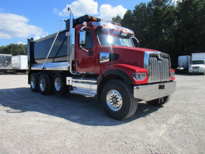 Western Star 49X dump truck in red, side view showing dump body and dual rear axles with chrome grille