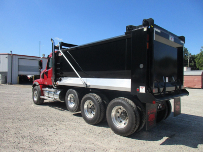 Western Star dump truck rear and side view showing bed, dual rear axle, and wheels.
