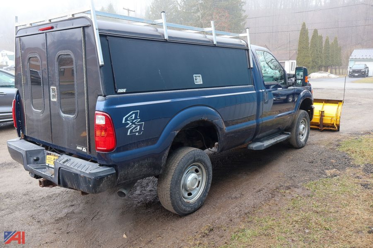 Ford F-350 Super Duty pickup with rear wheel drive 4x4, blue service body, dual rear doors, snow plow in background, VIN 1FTRF3B69GEA59554.