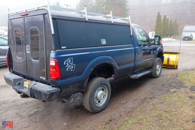 Ford F-350 Super Duty pickup with rear wheel drive 4x4, blue service body, dual rear doors, snow plow in background, VIN 1FTRF3B69GEA59554.