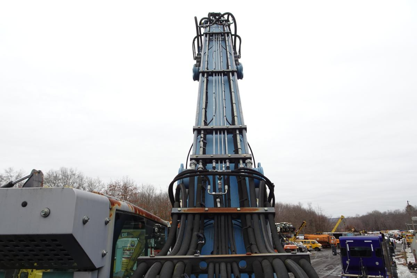 Telehandler boom and hoses with control cabin visible at bottom, no legible labels in close view.