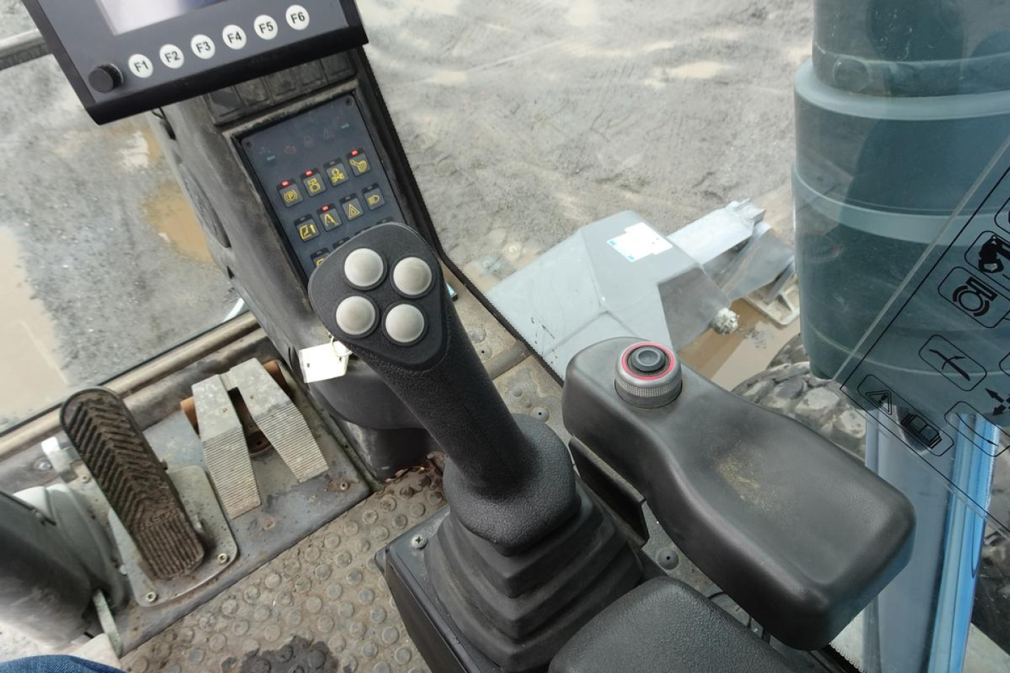 Classified image of Terex MHL 331 cab interior showing joystick with control buttons and monitor display.