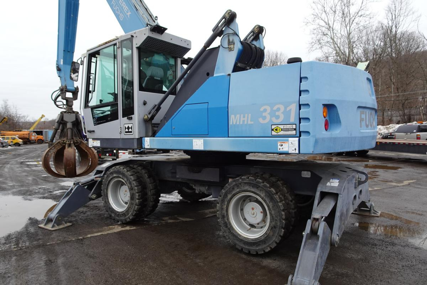 Terex MHL 331 mobile crane in blue, side view showing MHL 331 model number on rear, cab windows, hydraulic arm with hook, tires, and stabilizers.