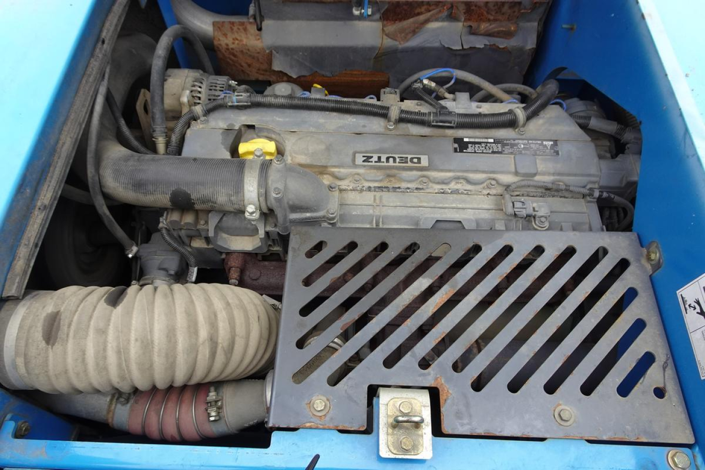 Diesel engine bay of Terex MHL 331 showing Deutz engine with air intake hoses and radiator guard.