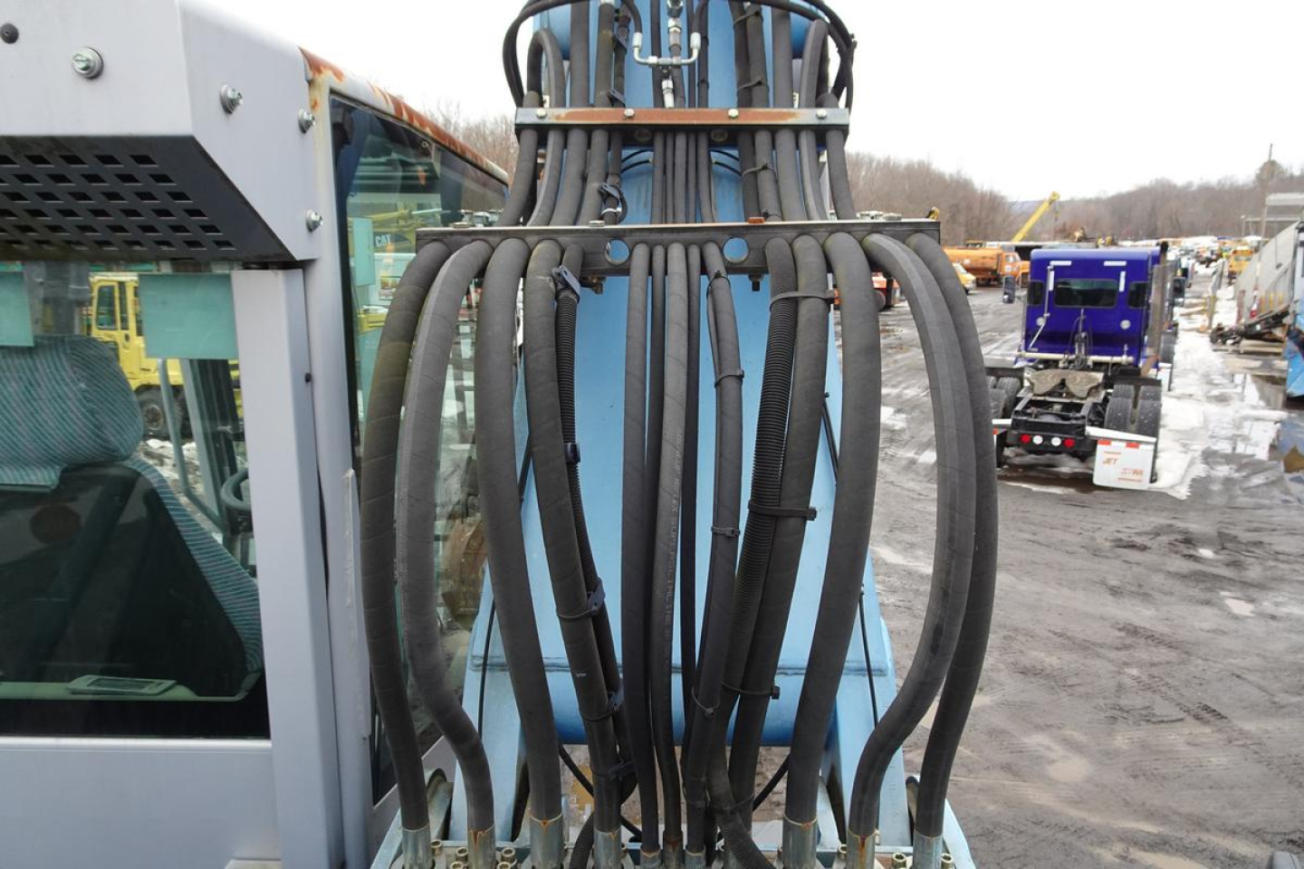 MHL 331 hydraulic boom hoses and attachment seen at side of Terex truck in service yard.
