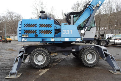 Terex MHL 331 hydraulic crane in blue showing 331 on the cab and side; visible labels and vents; front stabilizers deployed.