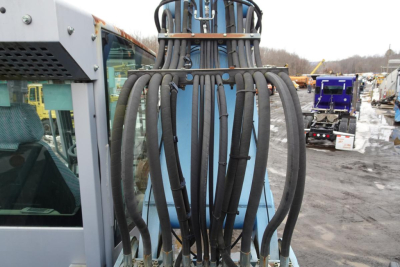MHL 331 hydraulic boom hoses and attachment seen at side of Terex truck in service yard.