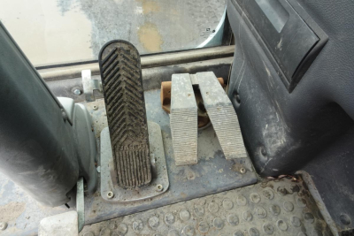 Pedals and foot controls in cab of 2012 Terex MHL 331 showing accelerator and two brake/clutch pedals with rubber surface and surrounding metal plate.
