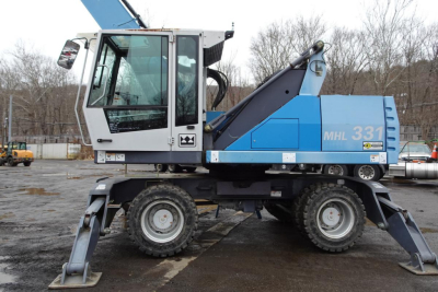 Terex MHL 331 material handler truck side view with blue body and white cab, MHL 331 decal visible, stabilizers lowered.