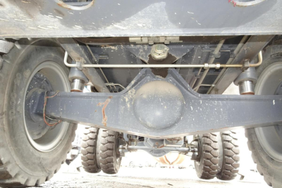 Terex MHL 331 undercarriage showing solid axle, dual rear wheels, driveline housing, and suspension components.