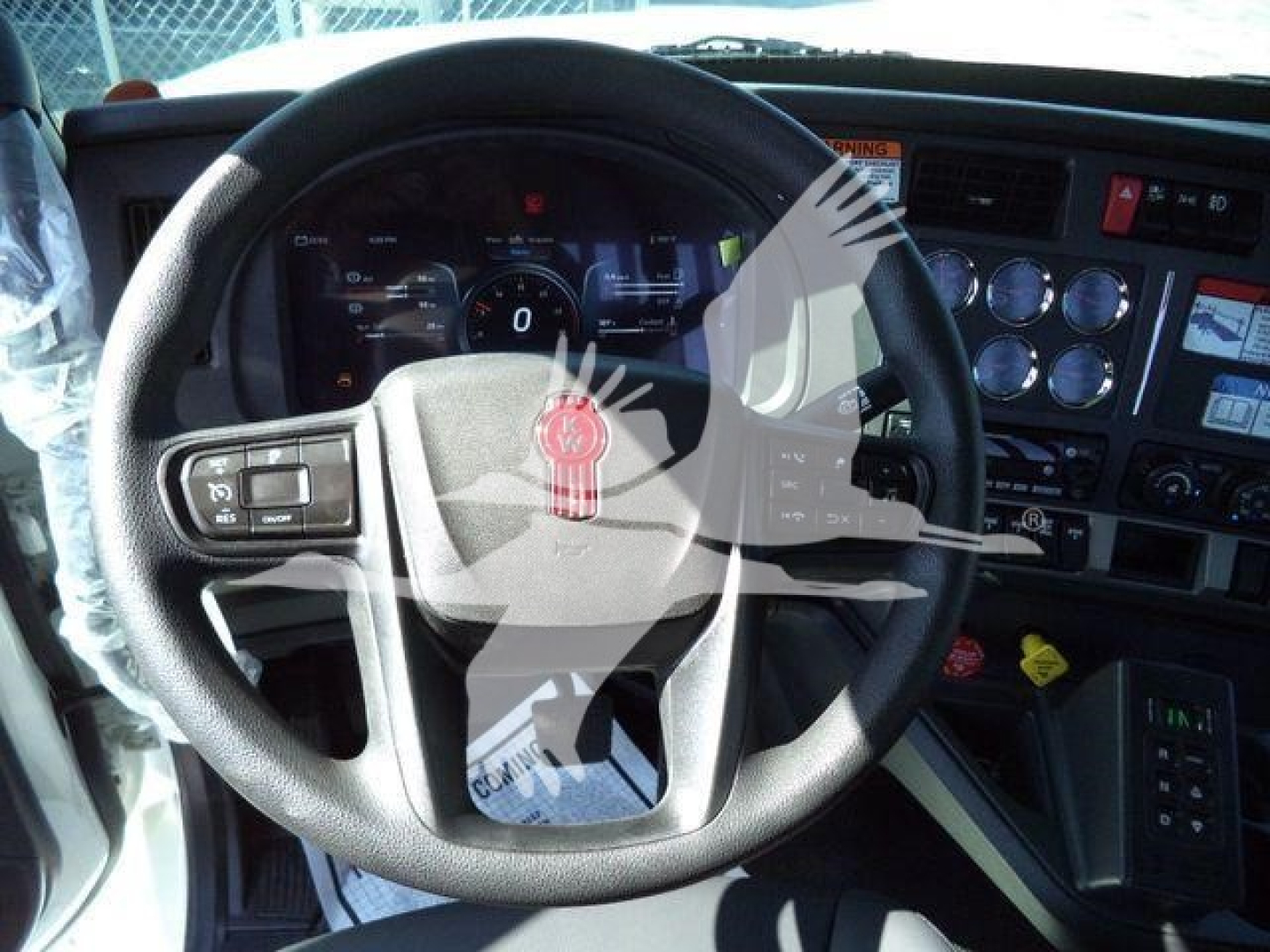 Kenworth T880 interior dashboard and steering wheel showing gauges and controls.