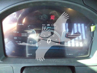 Kenworth T880 dashboard display showing digital gauge cluster with speedometer at zero, fuel and air pressure gauges, time 4:28 PM, 181°F coolant, 0.4 gal/min fuel flow, gear indicator 0, and Park assist icon.