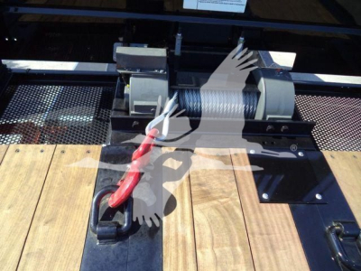 Kenworth T880 rollback truck hitch mechanism showing winch and wooden deck with metal frame.