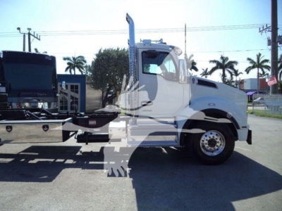 Kenworth T880 rollback truck side view showing cab, chrome exhaust stack, heavy chassis, and wheel with dual rear tires.