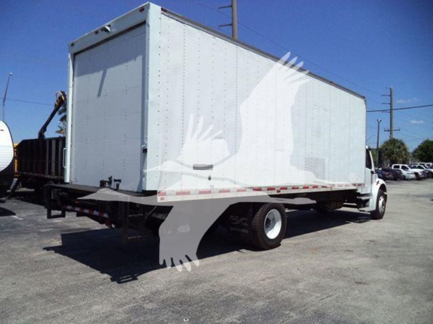 Box truck with a large cargo box on Freightliner M2 106 chassis, white exterior, rear and side view showing cargo box and cab.